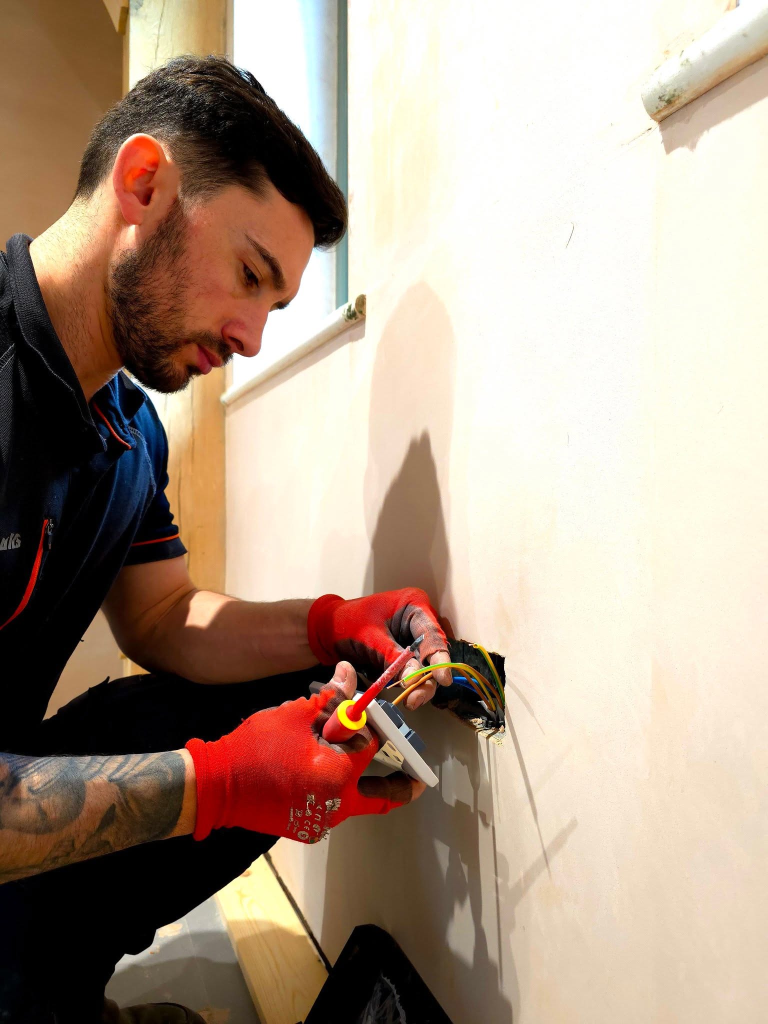 Nick McAllister, Hampshire Rewires electrician, wiring a socket